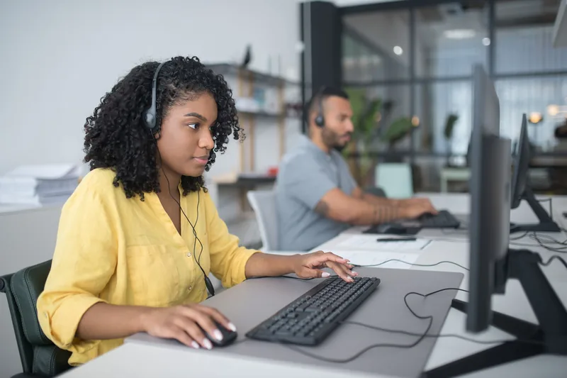 A support specialist at a desk